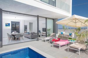 普罗塔拉斯Anassa Seaview Villa - Stunning Panoramic Views的一座带游泳池和庭院的房子