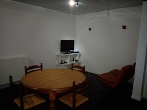 维泰勒Vittel location meublé的客厅配有桌子和电视