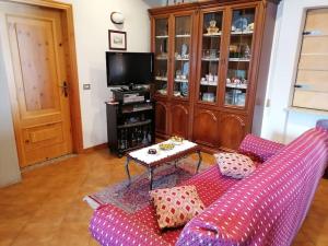 蒙切尼肖Chalet del paese Incantato的客厅配有紫色沙发和桌子