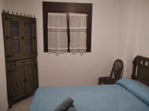 厄尔·布尔戈·德·奥斯马La casita del herrador的一间卧室配有一张床、一个梳妆台和一扇窗户。