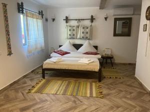穆里吉奥尔Casa Soarelui的一间卧室配有一张床,铺有木地板