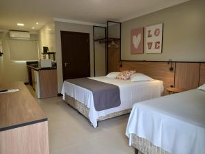 佩尼亚B14 Suítes的酒店客房带两张床和厨房