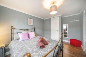 格拉斯哥Dalmarnock Stay的一间卧室配有带粉红色枕头的床