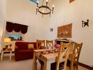 巴拉胡利什The Bothy of Ballachulish House的客厅配有桌子和红色沙发