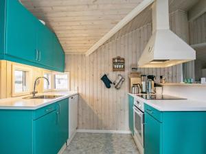 Helnæs By6 person holiday home in Ebberup的厨房配有蓝色橱柜和水槽
