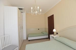德瓦玛丽娜克里斯公寓式酒店的一间卧室配有两张床和吊灯。