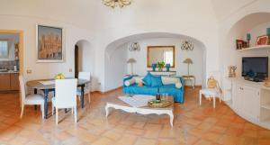 波西塔诺Casa Teodora - Positano的客厅配有蓝色的沙发和桌子