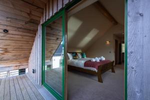 波特里Shore Cottage Isle of Skye的一间卧室设有一张床和一个玻璃门