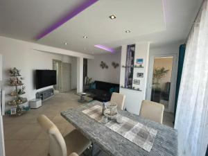 萨尔雷Luxury Beachhouse Apartment Boa Vista的客厅配有桌椅和电视。