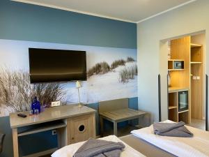米德尔哈根Hotel & Gasthof Zur Linde的一间卧室设有两张床,墙上配有电视。