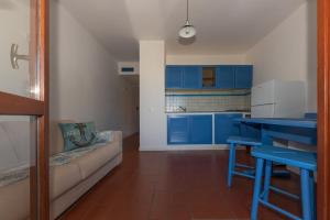 尼斯波特Elba Island Resort Pool & Tennis的一间厨房,内设蓝色橱柜和一张沙发