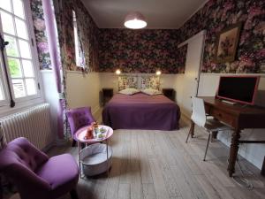 吉维尼艺术家园地旅馆的卧室配有床、书桌和钢琴