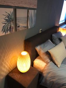 海牙Dunes & Sea at Kijkduin的一间卧室配有一张床和一张带台灯的桌子