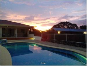 普拉亚埃尔莫萨Hermosa Paradise的一座享有日落美景的游泳池