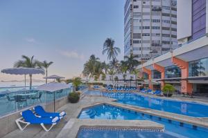 阿卡普尔科Gamma Acapulco Copacabana的一座配有桌椅的酒店游泳池