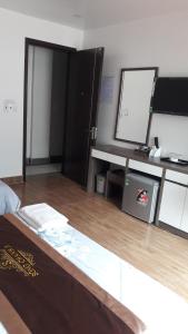 吉婆岛Khách sạn Sông Chanh 3 Cát Bà的客房设有一张床、一张书桌和一面镜子