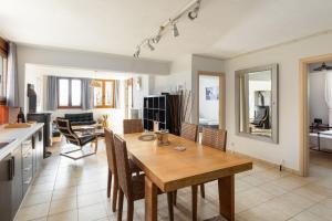 梅塔诺佛希斯#FLH - Vitamin Sea Beachfront Villa, Sithonia的厨房以及带木桌和椅子的客厅。