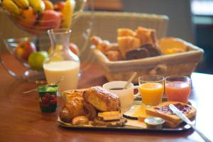 图尔hôtel QUICK Palace Tours Nord的一张桌子,上面放着一盘早餐食品和橙汁