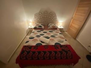 豪特尔Ti Kaz Marigot的一间卧室配有一张带红色和白色床罩的床。