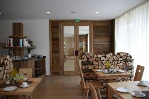 Sigmaringendorf贝姆瑞德维特酒店的一间设有木桌和一堆木柴的房间