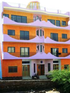 Tarrafal泽娜星公寓的一座橙色的建筑,旁边设有阳台