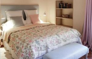 Fontaine-Henry瓦尔杜艾街度假屋的一间卧室配有一张带花卉床罩的大床
