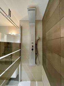 昂蒂布Superbe appartement, piscine, vue mer et montagnes的带淋浴的浴室,墙上配有电话