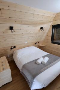 Saint-Christo-en-JarezÔ TIPI LODGE的卧室配有木墙内的一张床