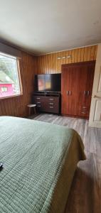 蒙特港El Capitán的一间卧室配有一张床和一台平面电视