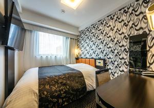APA Hotel Hakata Higashihieekimae客房内的一张或多张床位