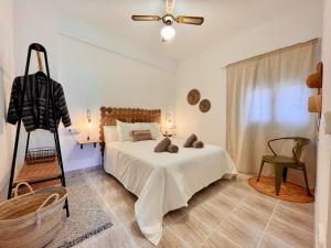 米乔尔海滩Apartamentos Carabela的卧室配有床、椅子和窗户。