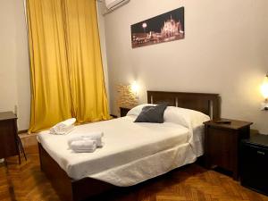 米兰Carlo Goldoni Hotel的一间卧室配有一张床,上面有两条毛巾