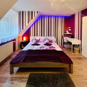 施普伦贝格Georgenberg的一间卧室设有一张紫色墙壁的大床