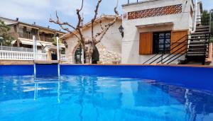 塔拉戈纳Family House - La Mora Beach - Tarragona的大楼前的大型蓝色游泳池
