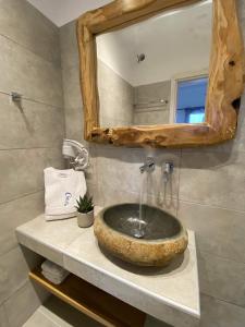 米克诺斯城Chill Out Studio的浴室设有石质水槽和镜子