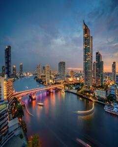 曼谷曼谷香格里拉大酒店 的城市天际线,夜晚有河流和桥梁