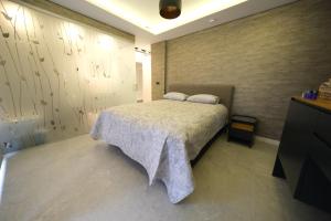 阿达纳Sky Garden Suites的一间卧室设有一张大床和一面墙