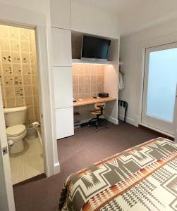 西雅图埃斯酒店西雅图的一间卧室配有一张床和一张带电脑的书桌