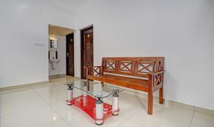 阿鲁法Treebo Trend Nirupama Apartment的一间带长凳和玻璃桌的房间