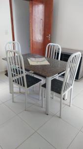 卡皮托利乌Cantinho Xodó的餐桌、两把椅子、一张桌子和一张桌子