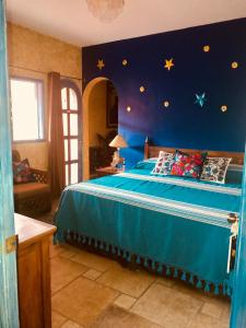 科苏梅尔Hacienda Boutique B&B and Spa Solo Adultos的卧室配有蓝色的床铺,墙上挂着星星