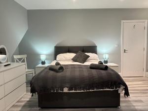 伯恩茅斯Entire spacious 4 bedroom apartment in Bournemouth的一间卧室配有一张大床和黑色棉被