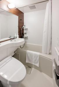 冈山Smile Hotel Okayama的白色的浴室设有卫生间和水槽。