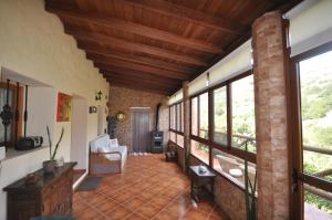 摩亚Casa Rural Casa Manuel的一间设有砖墙和窗户的大客厅