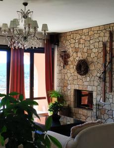 维蒂纳Vytina Mountain View Hotel的带沙发和石制壁炉的客厅