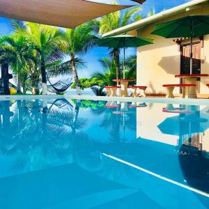 Puerto ArmuellesBig Daddy's Beach Club & Hotel的棕榈树游泳池及度假村