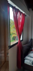内科克利Cabañas El Olimpo的室内的红色窗帘窗户