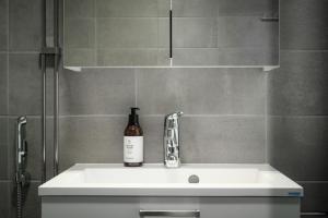 劳马Rauma City Center Studios的浴室内水槽上的一瓶葡萄酒