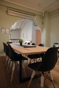 墨尔本CarricHostel的一间会议室,配有木桌和椅子