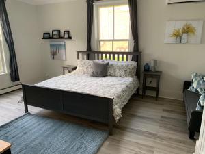 惠灵顿County Cove - Picton Suite的一间卧室配有带枕头的床